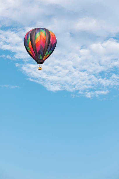 istock Hot Air Balloon Flying in Sky with Clouds 1279075360