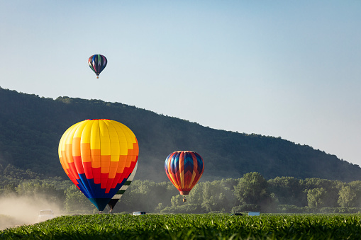 Landscape of fabulous Kapadokya. Colorful flying air balloons in sky at sunrise in Anatolia. Vacations in beautiful destination in Goreme, Turkey