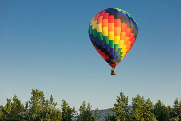 Hot Air Balloon Flying in a Blue Sky Colorful Hot Air Balloons Flying in a Blue Sky ballooning festival stock pictures, royalty-free photos & images