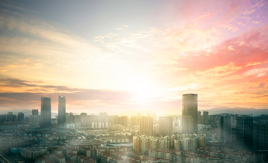 City day concept: view of Sunset over cityscape background