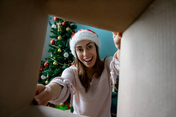 istock Woman looking very excited opening a Christmas gift 1279078105