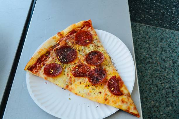 istock Slice of pizza on plate 1279080826