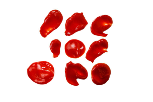 istock Red sauce splashes isolated on white background. Ketchup. 1279082555