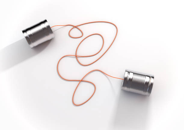 A pair of homemade toy telephones made from empty tin cans and connected wth a string on an isolated white background - 3D render