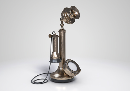 A vintage retro candlestick bell telephone made of brass on an isolated white background - 3D render