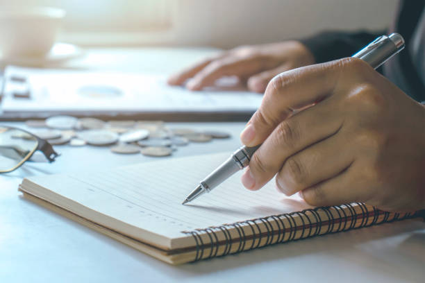 istock Man's hand, signature, filling in documents, or taking notes on financial documents. 1279083454
