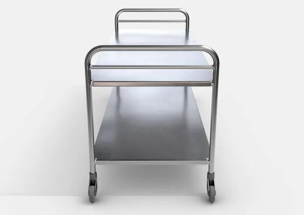 A simple stainless steel and chrome hospital or mortuary gurney with two flat surfaces and castor wheels on an isolated white background - 3D render