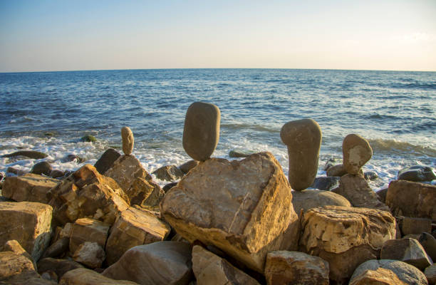 istock Balanced stones on the seashore summertime and sea waves background 1279086501