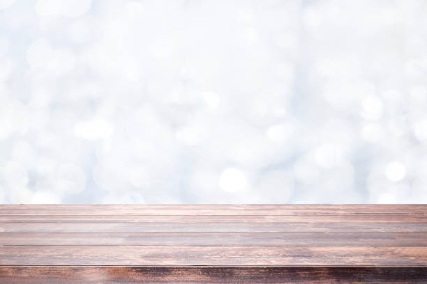 istock Wood table top on white bokeh abstract background. 1279087215