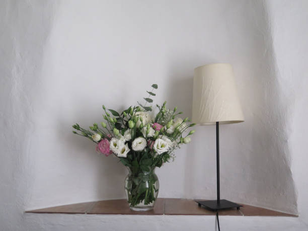 istock Wall recess with vase of white roses 1279092417