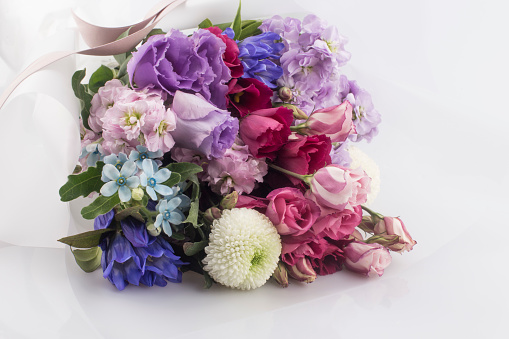 Beautiful pink, purple Lisianthus bouquet in full bloom with green leaves