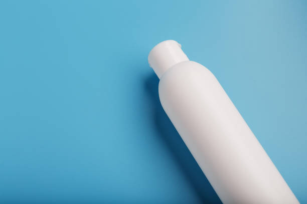istock White bottle on a blue background. Free space for text. 1279094072