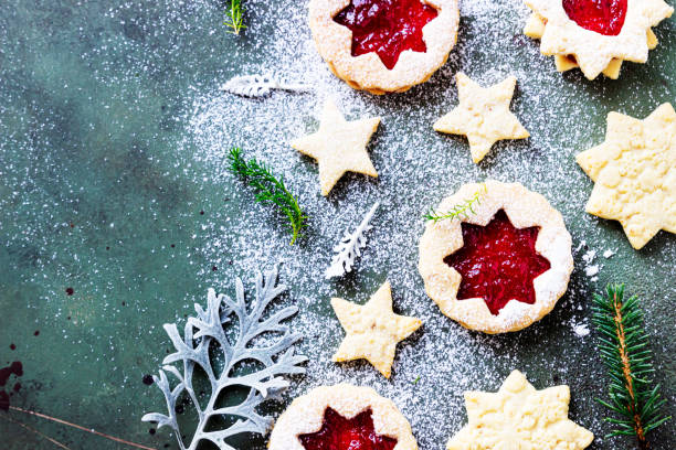 istock Traditional Linzer Christmas cookies with raspberry jam on green stone background. Flat lay. Festive decoration. 1279095133