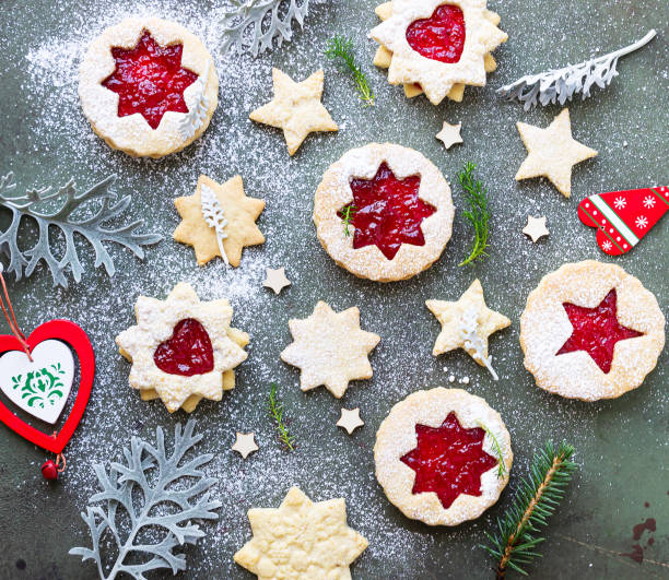 istock Traditional Linzer Christmas cookies with raspberry jam on green stone background. Flat lay. Festive decoration. 1279095363