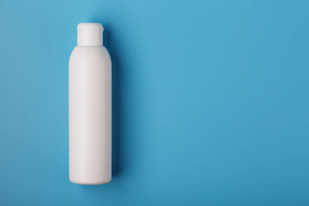 istock White bottle of cream on a blue background with space for text. Free space for text. 1279095385