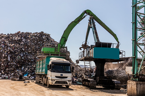 Grab crane works in waste recycling station