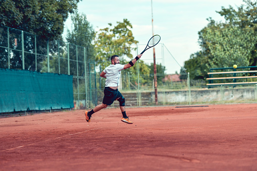 Male Tennis Player Giving His Best During Match