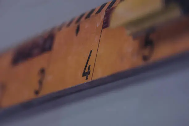 An old school ruler made of wood in selective focus