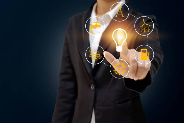 istock Business people holding energy-saving lamps. The work includes environmentally friendly energy source icons, energy saving ideas, and environmentally friendly campaigns. 1279102101
