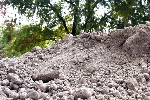 soil pile, dirt hill for agriculture and construction building site, soil mound dirt white