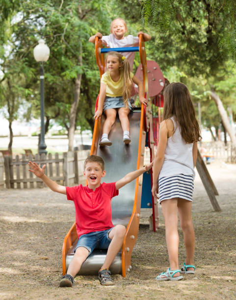 istock Kids playing on sliding toy 1279103187