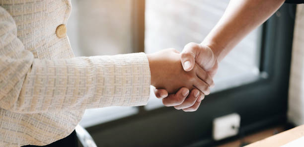 istock Manager and employee interview concept with handshake after talking about contract signing. 1279103529