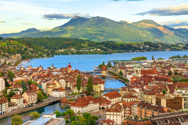 Lucerne skyline aerial Aerial view of Lucerne skyline and lake Lucerne with Mount Rigi and its peak Rigi-Kulm in the Canton of Lucerne, Switzerland. Amazing panorama with sunset orange clouds and green hills. lucerne switzerland stock pictures, royalty-free photos & images