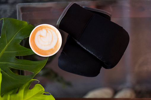 Top shot cappuccino and kickboxing gloves background