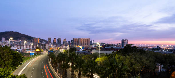 istock Panoramic light trails on highway into city at dawn essential services transport during COVID-19 lockdown 1279105259
