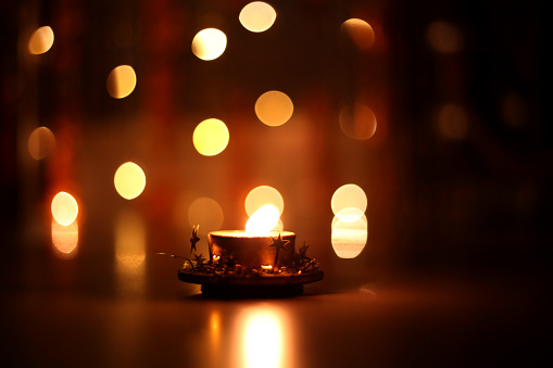 Decorative oil lamp burning at night on Diwali festival.