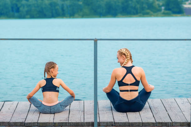 istock Mother and daughter doing gym exercises 1279108515