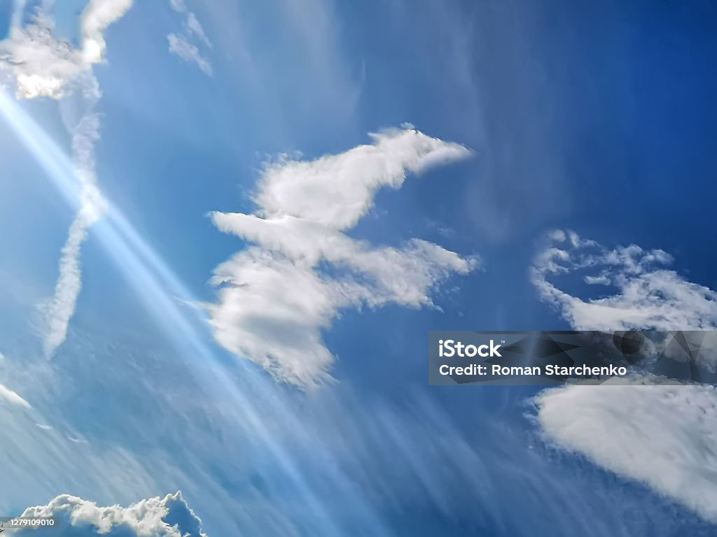 A cloud in the form of a white dove against a blue sky. Concept of god A cloud in the form of a white dove against a blue sky. Concept of god. Background texture. Pentecost - Religious Celebration Stock Photo