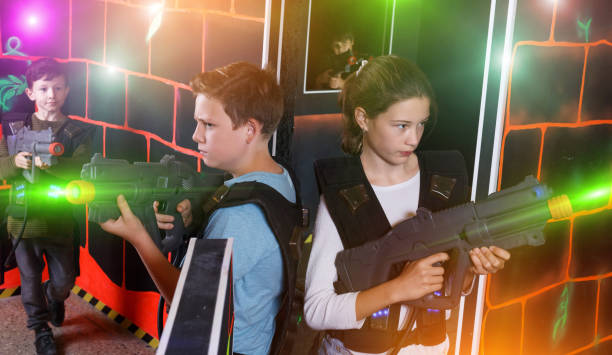 istock Girl and boy playing laser tag 1279110126