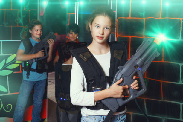 istock girl with laser pistol posing in laser tag labyrinth 1279110139
