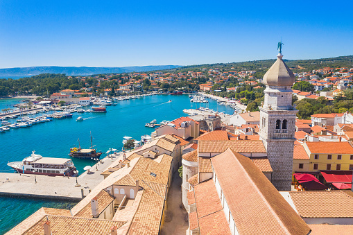 Aerial view of the old town of Krk in Croatia, cathedral tower and marina in background