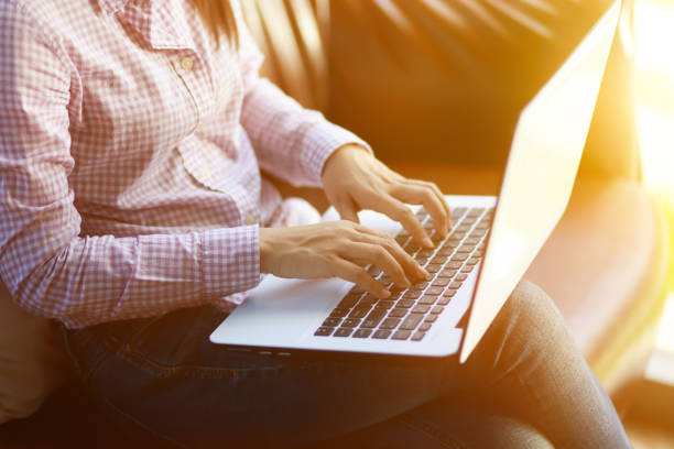 istock Freelancing woman using laptop computer for distance job while sitting in coffee shop. Business woman typing on laptop at workplace Woman working in home office hand keyboard. 1279112324