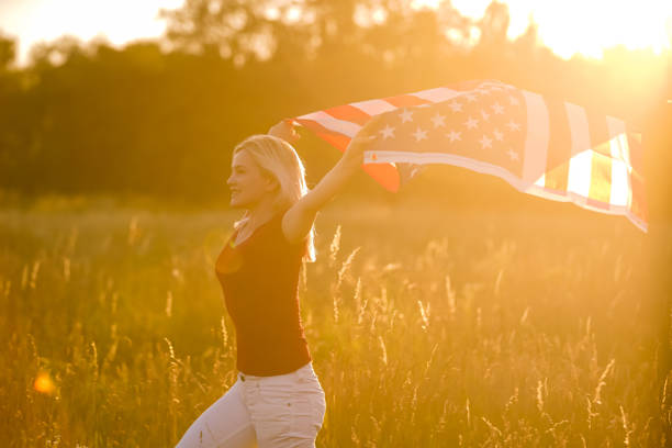 istock Beautiful Young Woman with USA Flag 1279112430