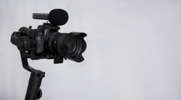 istock modern dslr camera on 3-axis gimbal stabilizer with microphone over gray background 1279112961