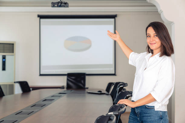 istock Businesswoman Presenting Data on Video Screen 1279113016