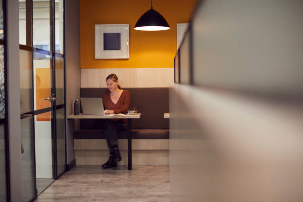 istock Businesswoman Working Late In Open Plan Office Using Laptop 1279113074