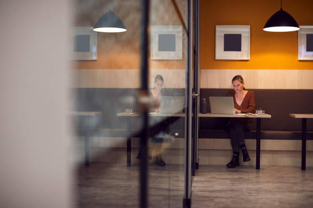 istock Businesswoman Working Late In Open Plan Office Using Laptop 1279113097