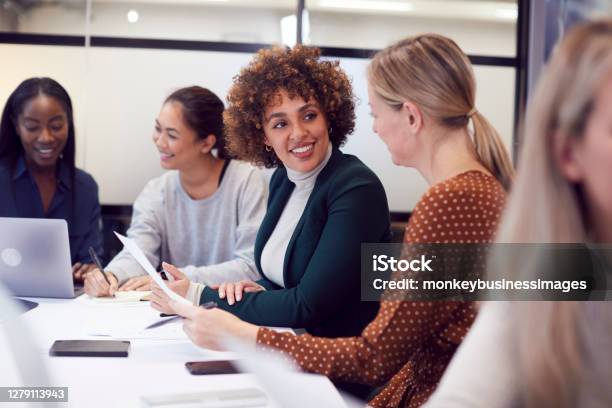 Group Of Businesswomen Collaborating In Creative Meeting Around Table In Modern Office Stock Photo - Download Image Now
