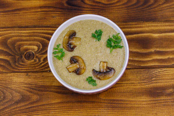 istock Mushroom cream soup on a wooden table. Top view 1279114105