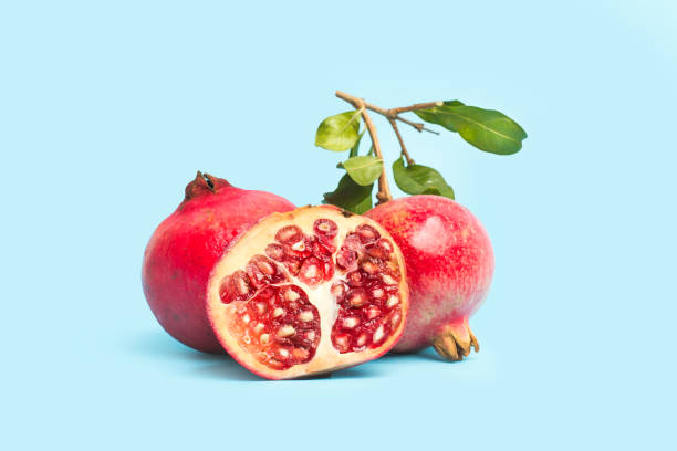 istock Pomegranates with branches and leaves 1279115759