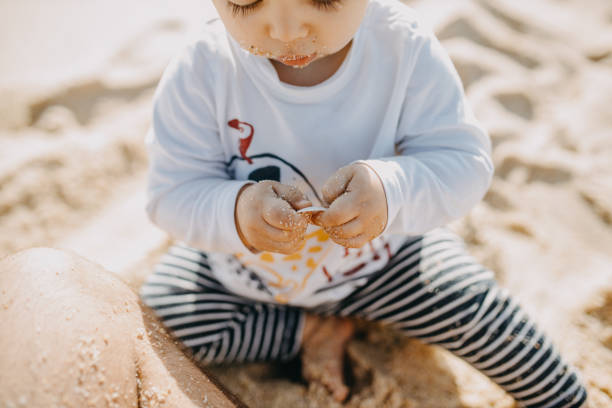 istock High Angle View Of Boy Sitting On Beach 1279115895