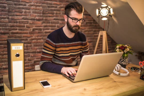 istock Young man using a laptop and working in the office 1279116772