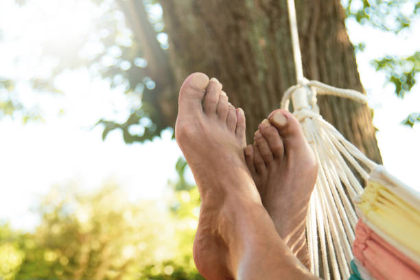 feet lying in hammock resting in summer outdoors