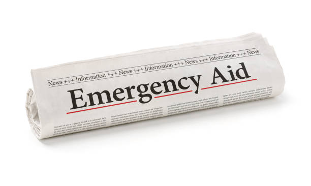 istock Rolled newspaper with the headline Emergency Aid 1279116842