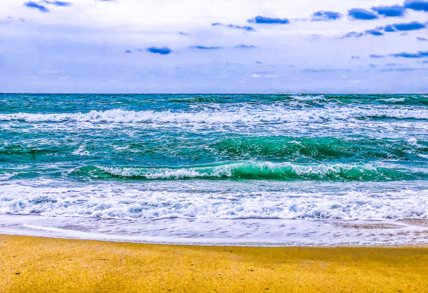 istock Blue sky, green water and shiny sand 1279116957