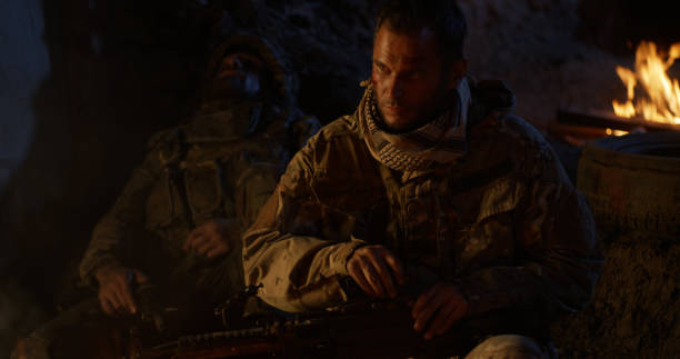 istock Soldier resting near fire at night 1279117595